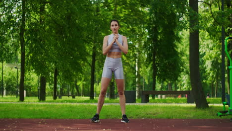 Female-athlete-performs-side-lunges-work-out-her-legs-in-the-Park-in-slow-motion.-Beautiful-woman-playing-sports-in-the-Park.